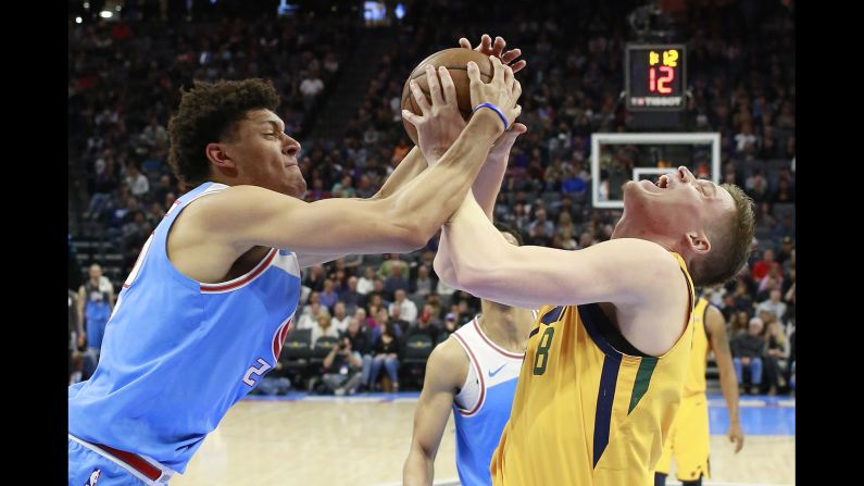 Sacramento's Justin Jackson, left, and Utah's Jonas Jerebko battle for the ball during an NBA game in Sacramento, California, on Saturday, March 3.