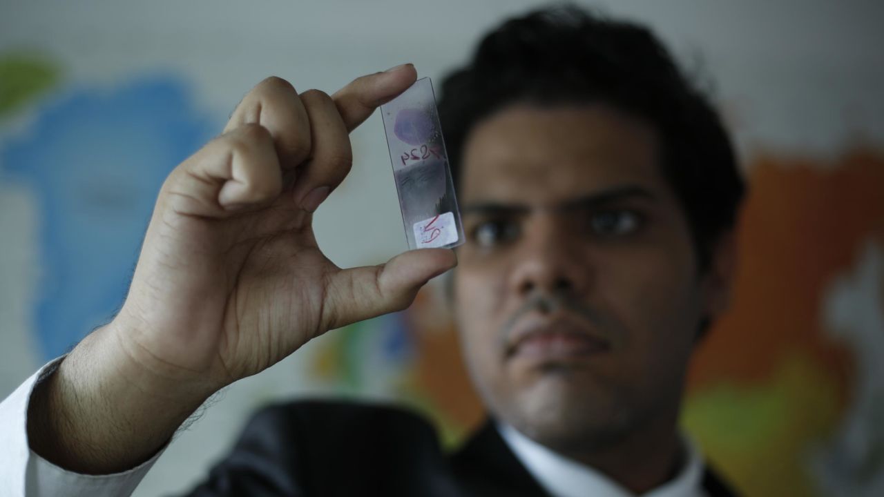 Rainier Mallol holds up a sample slide.