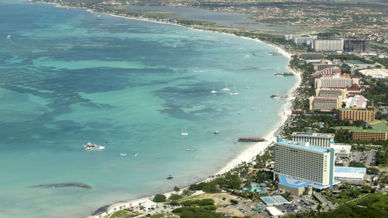 <strong>Aruba:</strong> Palm Beach offers long expanses of powdery sand and blue-green water clear enough for a dive to see the frolicking fish.<br />