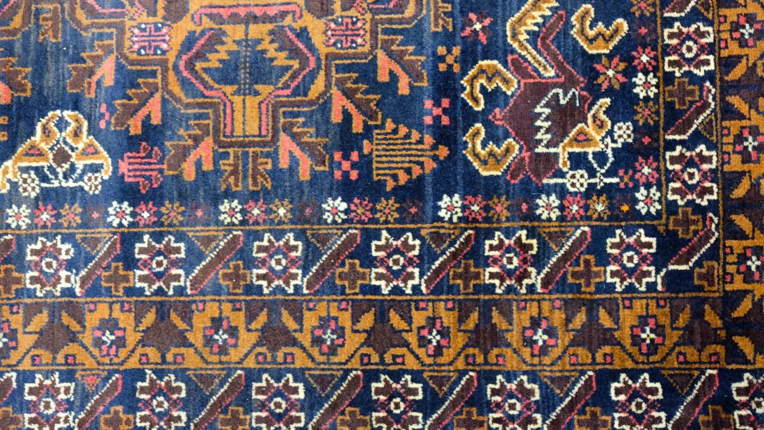 <strong>Balochi rug:</strong> The browns in this rug made by Balochi tribe members are created using fresh walnuts and madder root. The dark blues come from indigo and ferrous oxide. "This rug is 35 years old," says Bhat. "It's a magnificent <em>sofra</em> -- a dining table."