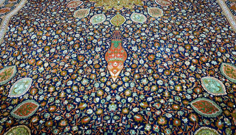 <strong>Ardabil Carpet: </strong>Made in the 1960s by Bhat's family, this shimmering blue carpet is a silk redesign of a famous Persian wool creation from 1540 known as "<a href="index.php?page=&url=https%3A%2F%2Fwww.vam.ac.uk%2Farticles%2Fthe-ardabil-carpet%3Fgclid%3DCj0KCQiAuP7UBRDiARIsAFpxiRKGnNtgKMWPzhvZIz_djKGosINHe-4ah2qYiTuyhpZ09KASUEUaIh0aAgCYEALw_wcB" target="_blank" target="_blank">The Ardabil Carpet</a>" that's on display in London's V&A museum. Bhat says the reproduction took four years to complete and contains 9,525,600 knots. It's estimated cost is *8,500.