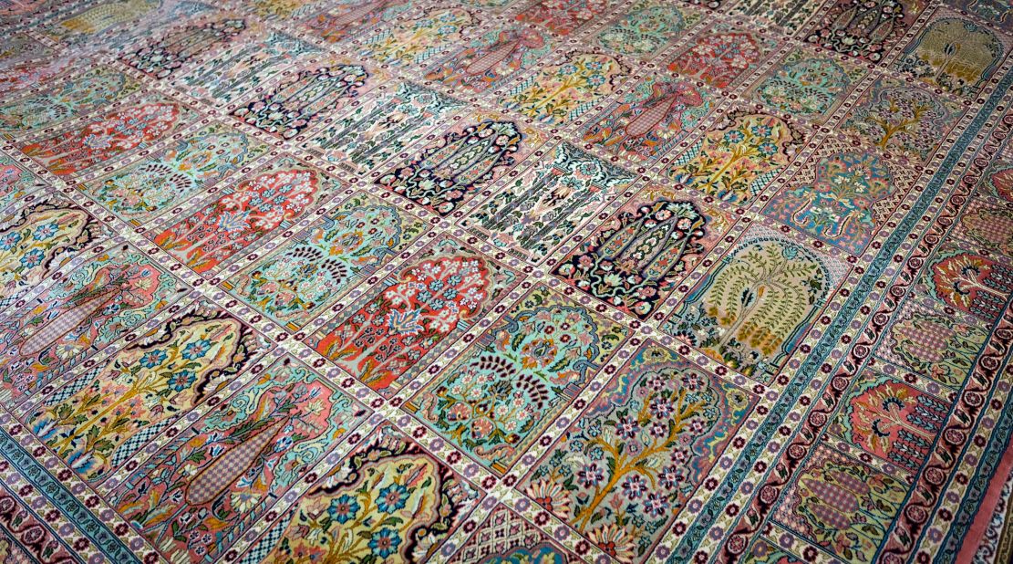 <strong>Doors of Heaven:</strong> This silken Kashmiri rug shows symbols such as the doors of heaven and the tree of life. Bhat says the beautiful greens are created using dyes made from fresh pistachios.