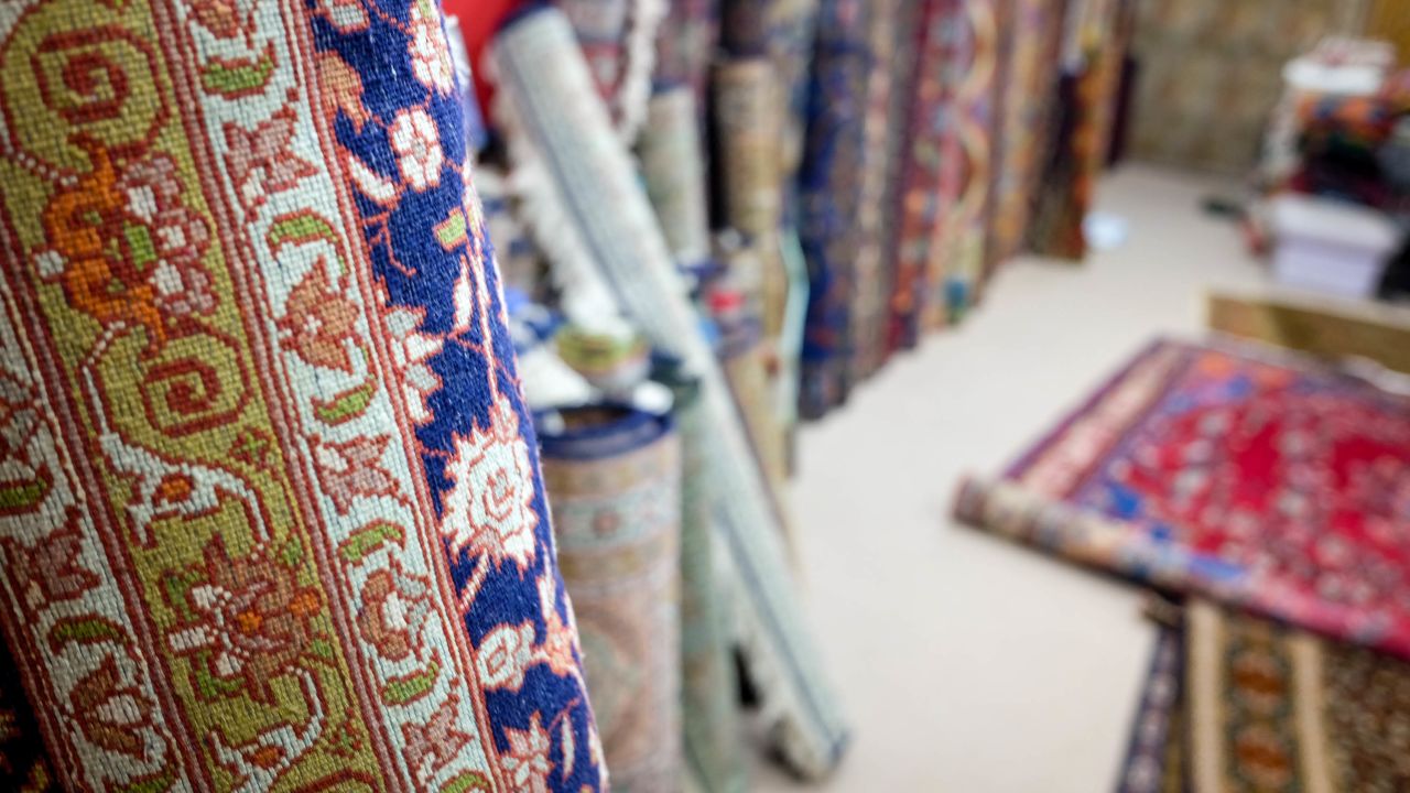 Bhat says he knows the story behind every single rug in his shop.