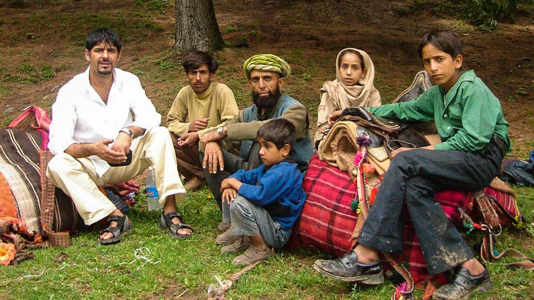 <strong>Afghan adventures: </strong>Since his first foray in 1988, Bhat has made numerous return trips to Afghanistan in search of rugs. This image, taken in 1997, shows Bhat, on the left, with some Afghans he met in the country's eastern Nuristan province. 