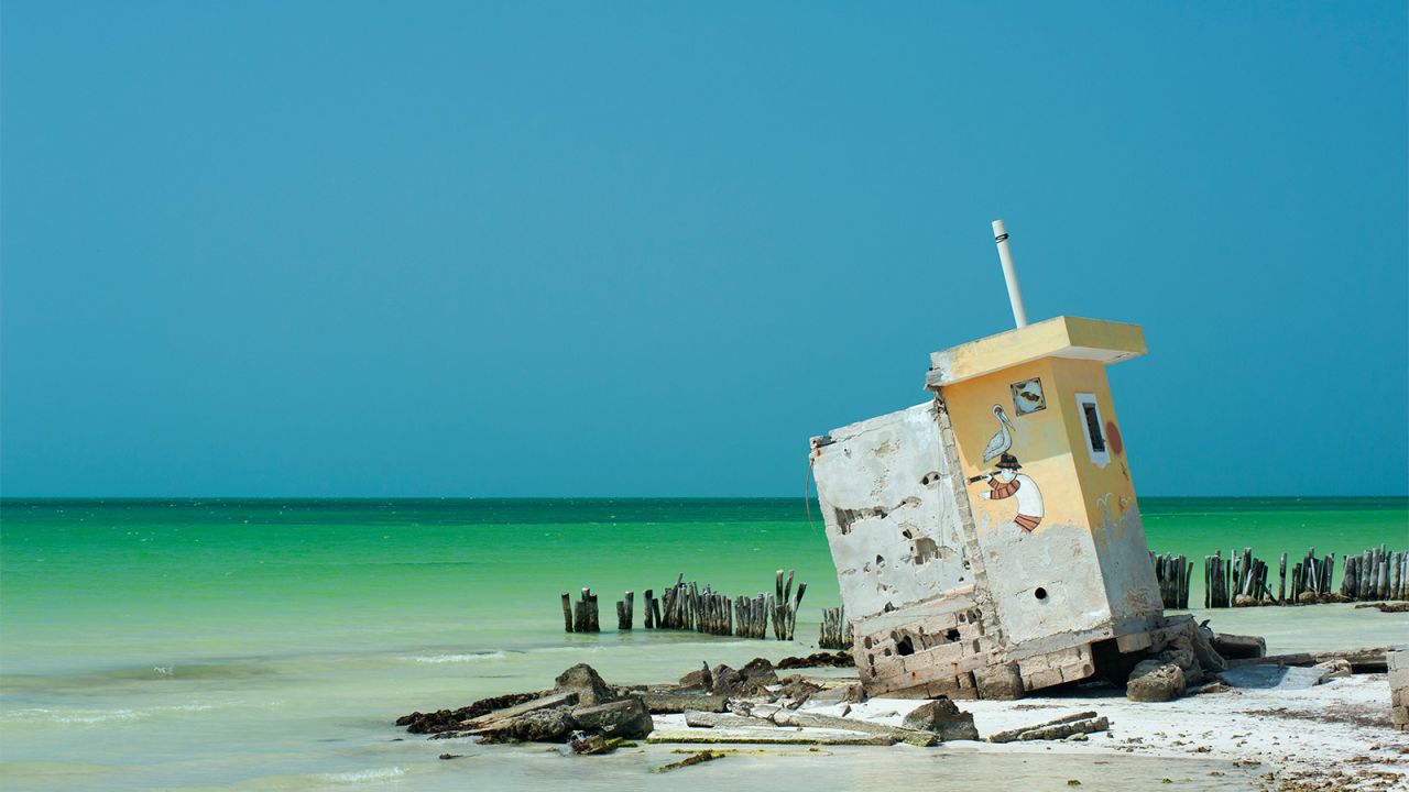 <strong>Among the ruins:</strong> The best way to explore Holbox is by walking along the beach. That's where you will find gems like this former public bathroom that is now slowly collapsing into the sea.