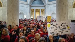 Striking school workers hold signs and chant inside the West Virginia Capitol in Charleston, West Virginia, U.S., on Friday, March 2, 2018. 