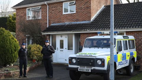 Police officers stand outside the home of former Russian spy Sergei Skripal following his alleged poisoning.