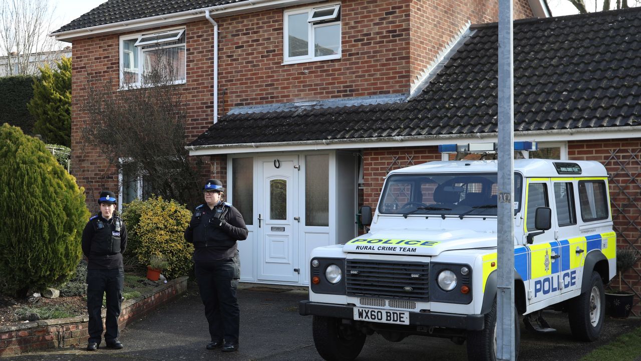 Police officers stand outside Sergei Skripal's home in Salisbury.
 