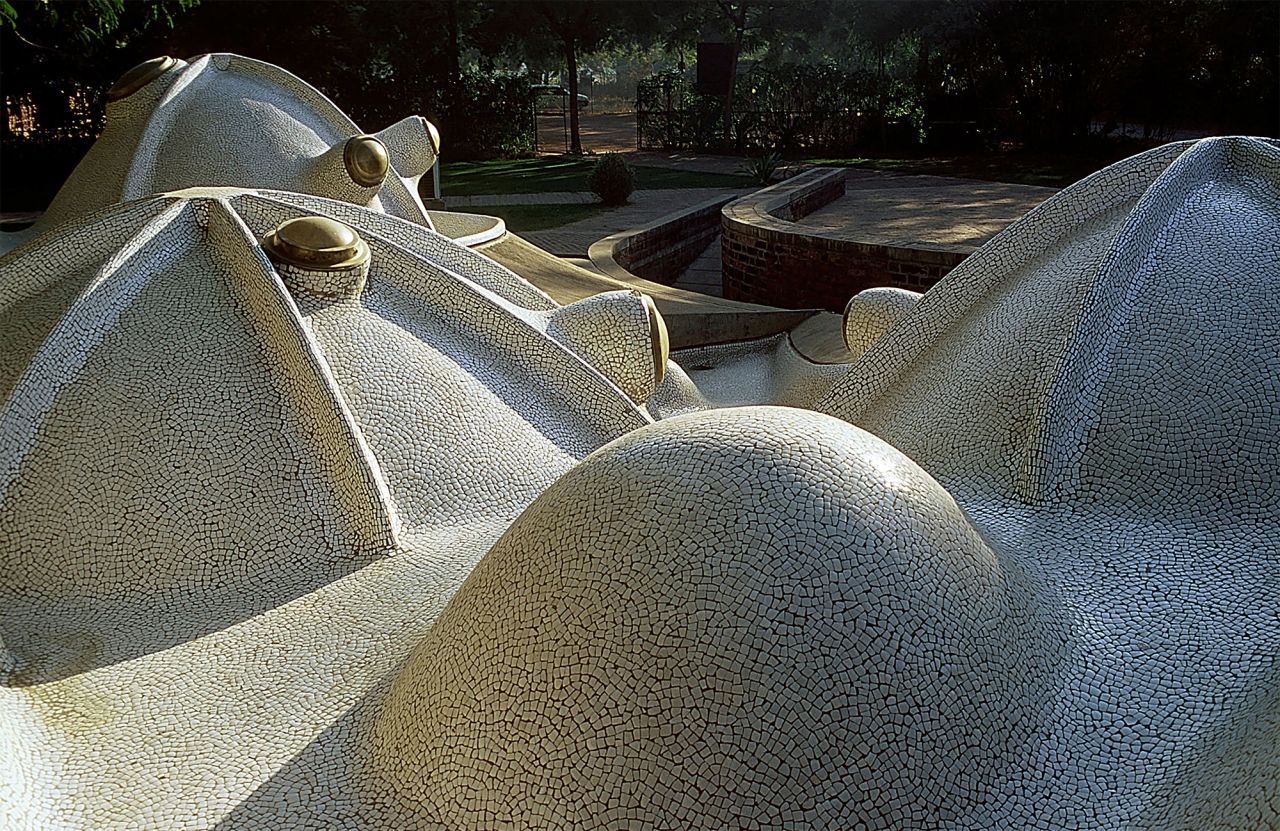 Amdavad ni Gufa, a subterranean museum with domed roofs that protrude playfully above ground.