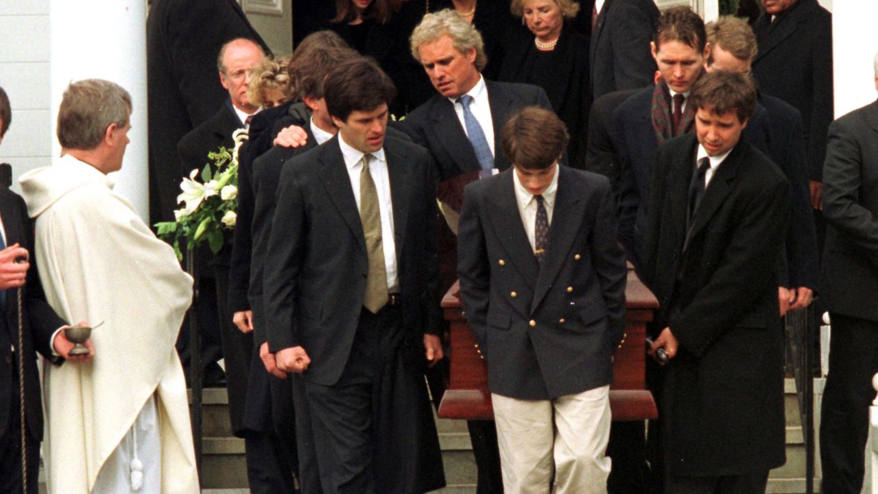 Family members carry a casket with the body of Michael Kennedy following a memorial service in 1997.