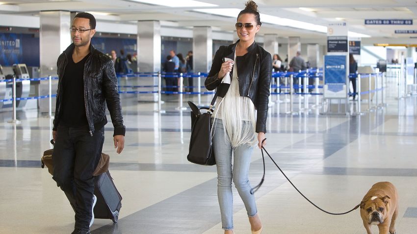 John Legend and Chrissy Teigen are seen at Los Angeles International Airport on February 16, 2013 in Los Angeles, California.