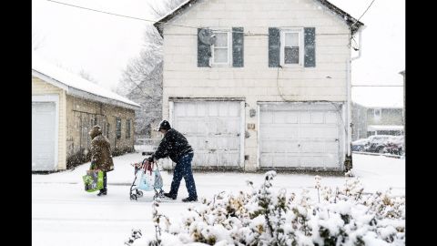 People make their way through snow Wednesday in Quakertown, Pennsylvania, north of Philadelphia.