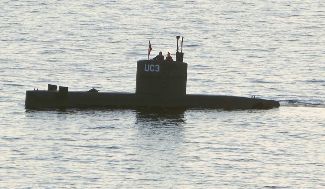 A woman alleged to be Kim Wall stands next to a man in the tower of the private submarine UC3 Nautilus on August 10, 2017, in Copenhagen harbor. 