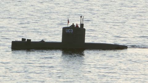 A woman alleged to be Kim Wall stands next to a man in the tower of the private submarine UC3 Nautilus on August 10, 2017, in Copenhagen harbor. 
