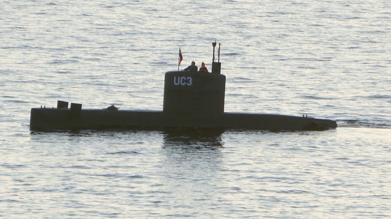 A woman alleged to be Kim Wall stands next to a man in the tower of the private submarine UC3 Nautilus on August 10 in Copenhagen Harbor. 