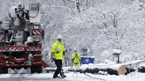 A worker pulls downed lines as a crew tries to restore power Wednesday in Morristown, New Jersey.