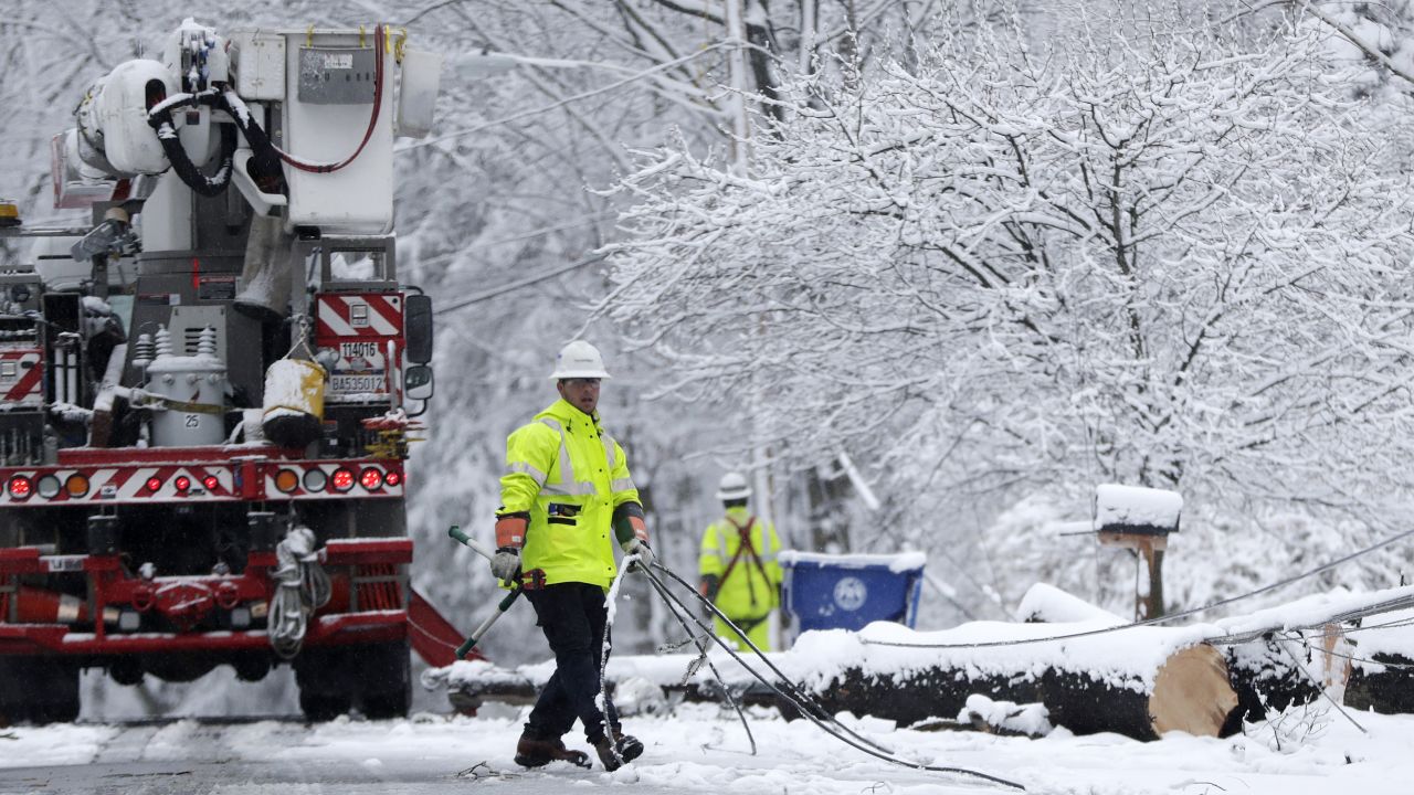 A worker pulls downed lines as a crew tries to restore power Wednesday in Morristown, New Jersey.