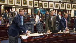 Florida Rep. Jason Brodeur, left, (R- Sanford), watches the vote board as he votes on the school safety bill which passed the House 67-50 at the Florida Capital in Tallahassee, Fla., Wednesday, March 7, 2018. (AP Photo/Mark Wallheiser)
