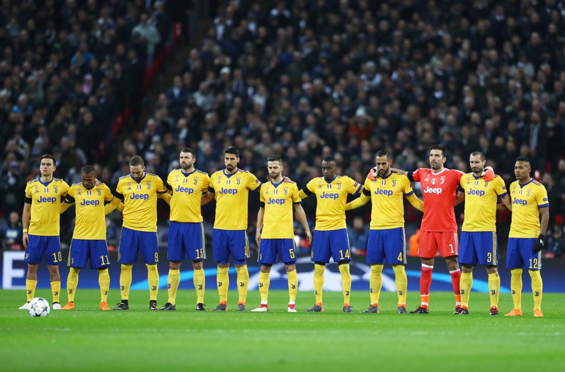 Juventus players link arms during minute's silence in memory of Davide Astori.