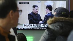 People watch a TV screen showing North Korean leader Kim Jong Un, left, meeting with South Korean National Security Director Chung Eui-yong in Pyongyang, North Korea, at the Seoul Railway Station in Seoul, South Korea, Wednesday, March 7, 2018. After years of refusal, North Korean leader Kim Jong Un is willing to discuss the fate of his atomic arsenal with the United States and has expressed a readiness to suspend nuclear and missile tests during such talks, a senior South Korean official said Tuesday. Korean characters seen on the screen read: "South Korea-U.S. joint military drills." (AP Photo/Ahn Young-joon)