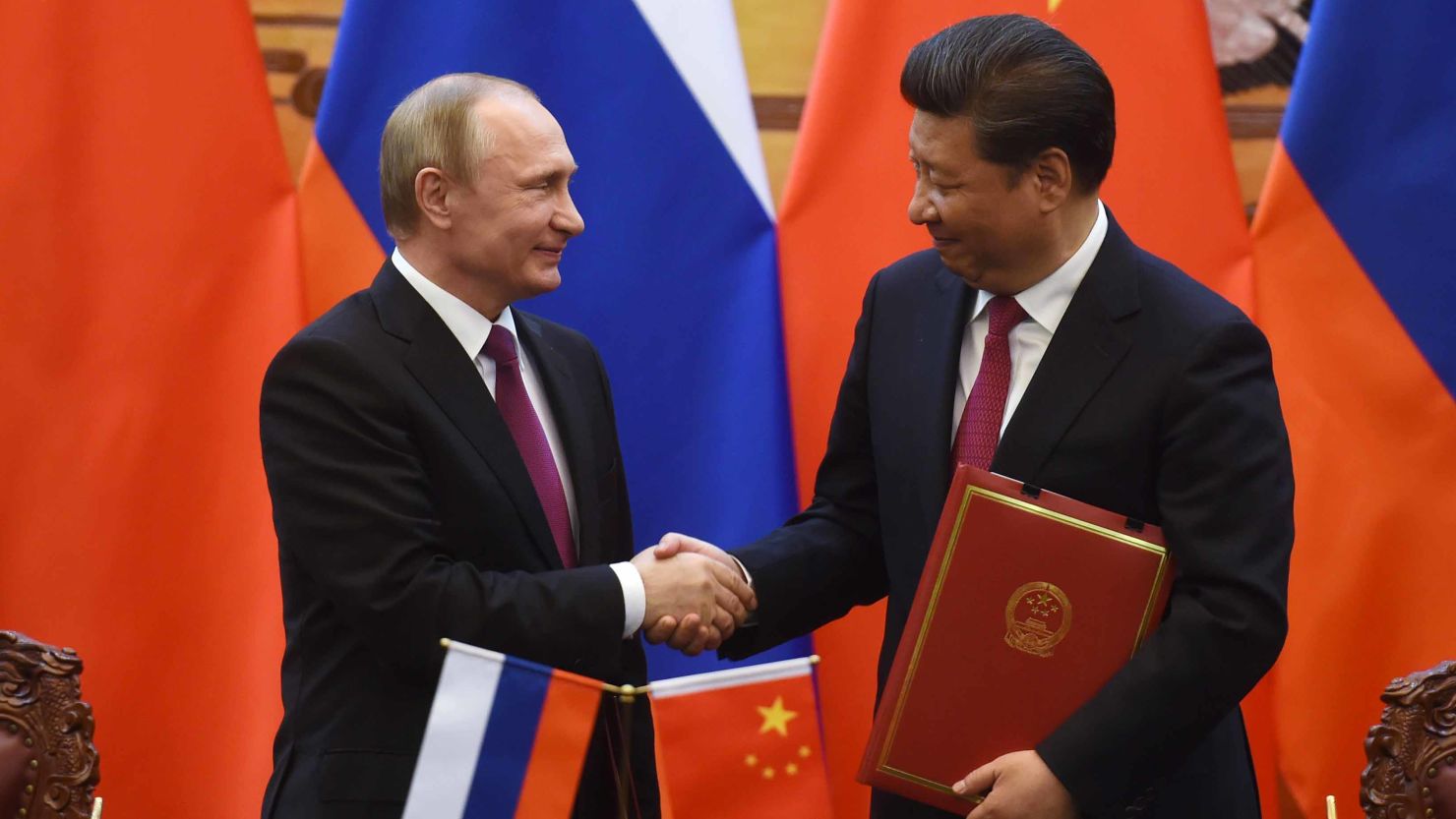 Russian President Vladimir Putin (L) shakes hands with Chinese President Xi Jinping during a signing ceremony in Beijing's Great Hall of the People on June 25, 2016 in Beijing, China.