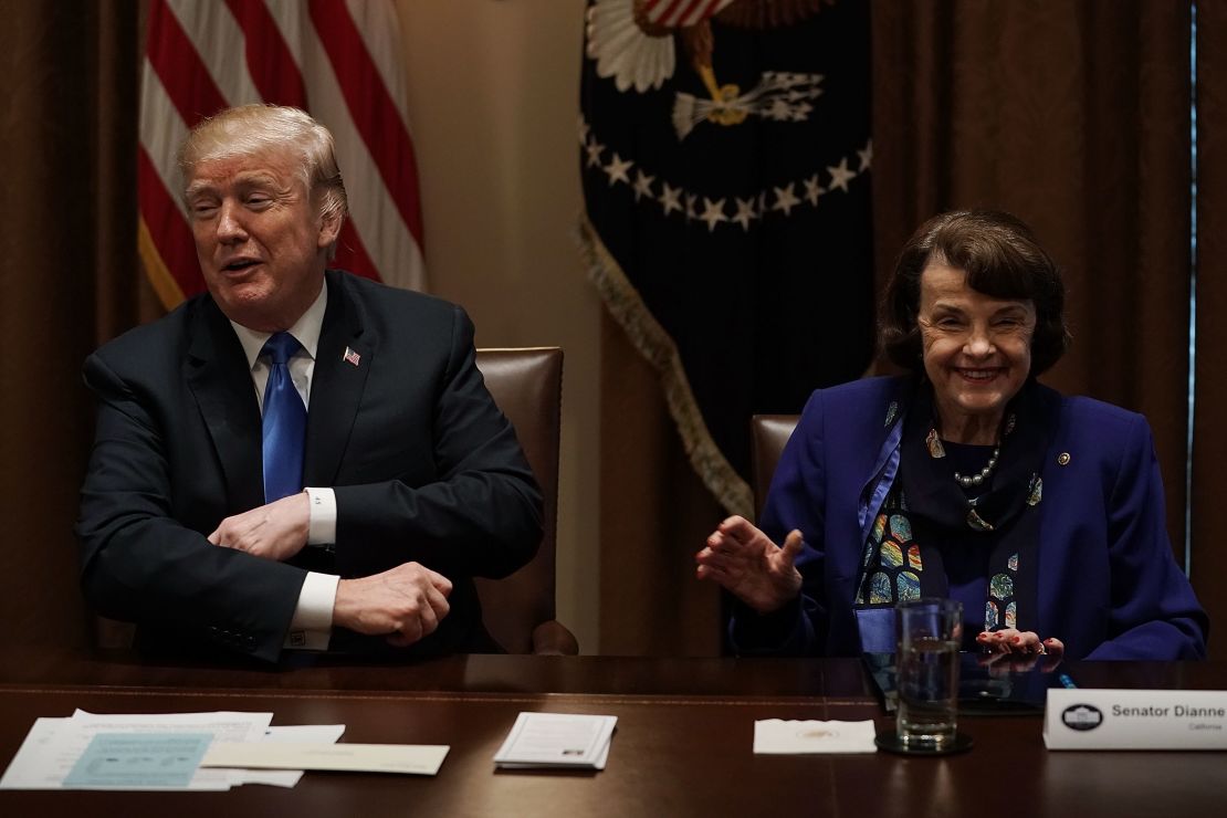 President Donald Trump and Democratic Sen. Dianne Feinstein of California share a moment during a meeting with bipartisan members of the Congress at the Cabinet Room of the White House on February 28, 2018 in Washington, DC. 