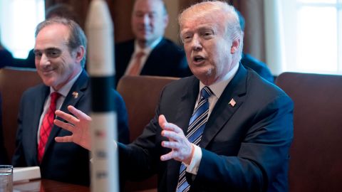 President Donald J. Trump gestures behind a model of a rocket beside US Secretary of Veterans Affairs David Shulkin during a meeting with members of Trump's  Cabinet, in the Cabinet Room of the White House on March 8, 2018 in Washington, DC.