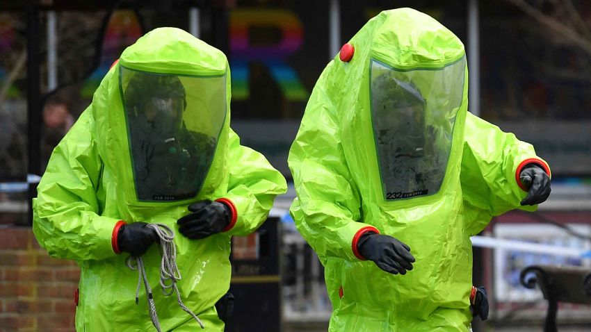 Members of the emergency services in green biohazard suits work to afix the tent over the bench where a man and a woman were found on March 4 in critical condition at The Maltings shopping centre in Salisbury, southern England, on March 8, 2018 after the tent became detached. 
British detectives on March 8 scrambled to find the source of the nerve agent used in the "brazen and reckless" attempted murder of a Russian former double-agent and his daughter. Sergei Skripal, 66, who moved to Britain in a 2010 spy swap, is unconscious in a critical but stable condition in hospital along with his daughter Yulia after they collapsed on a bench outside a shopping centre on Sunday.
 / AFP PHOTO / Ben STANSALL        (Photo credit should read BEN STANSALL/AFP/Getty Images)