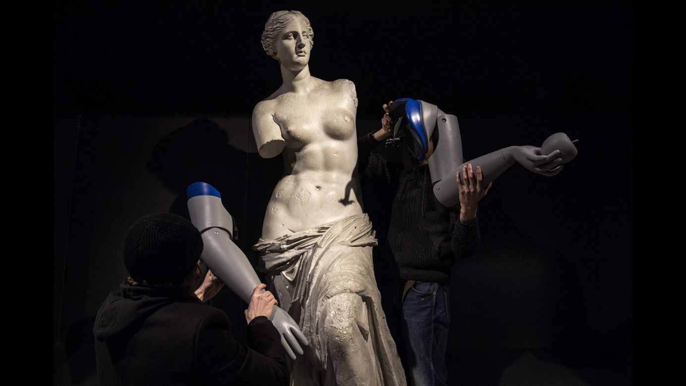 Men dismantle prosthetic arms from a Venus de Milo replica that was at a metro station in Paris on Tuesday, March 6. The statue was meant to raise awareness about the thousands of amputees worldwide who are in need of a prosthesis.