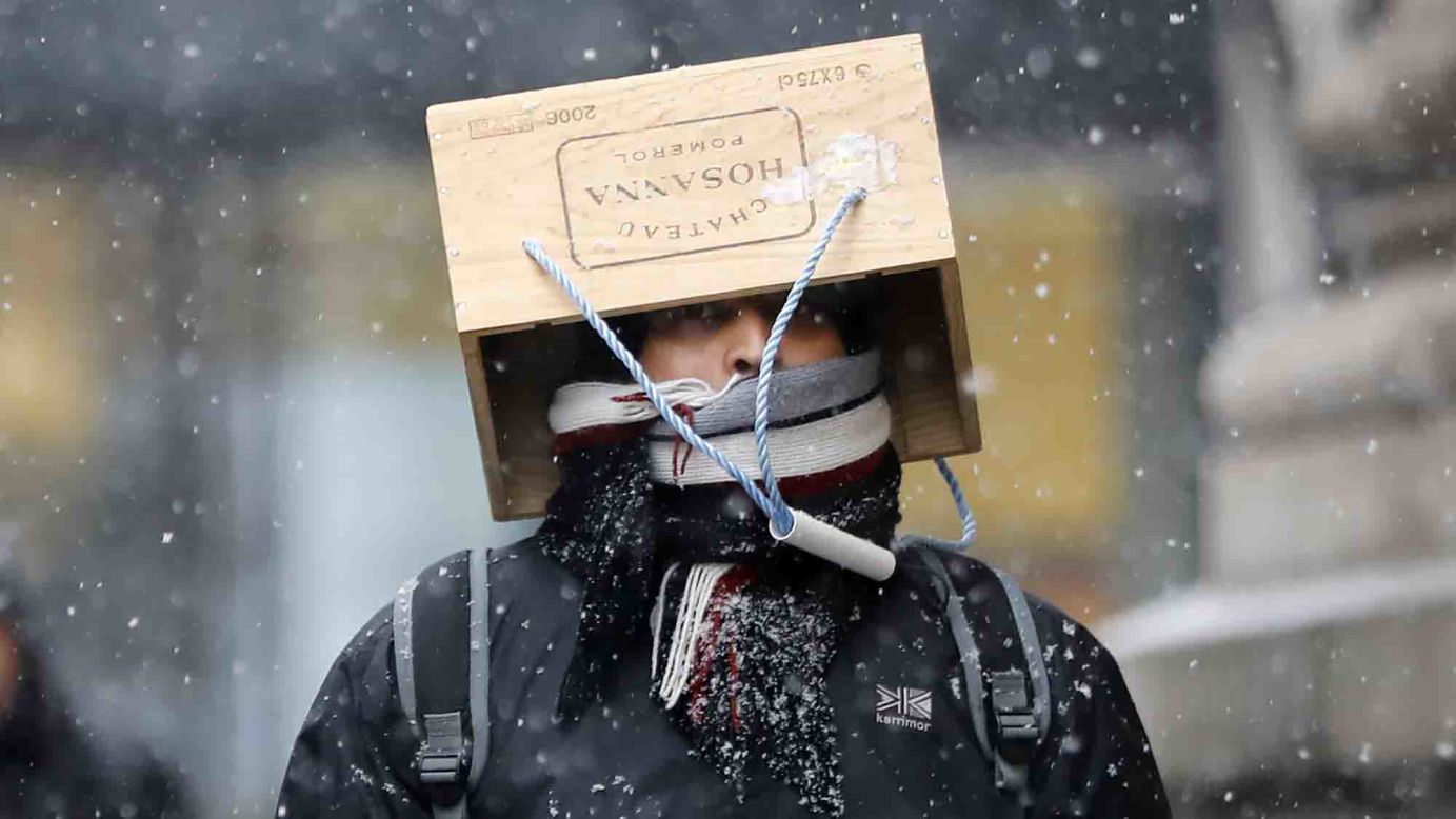 A pedestrian wears an unusual hat during a blizzard in London on Friday, March 2.