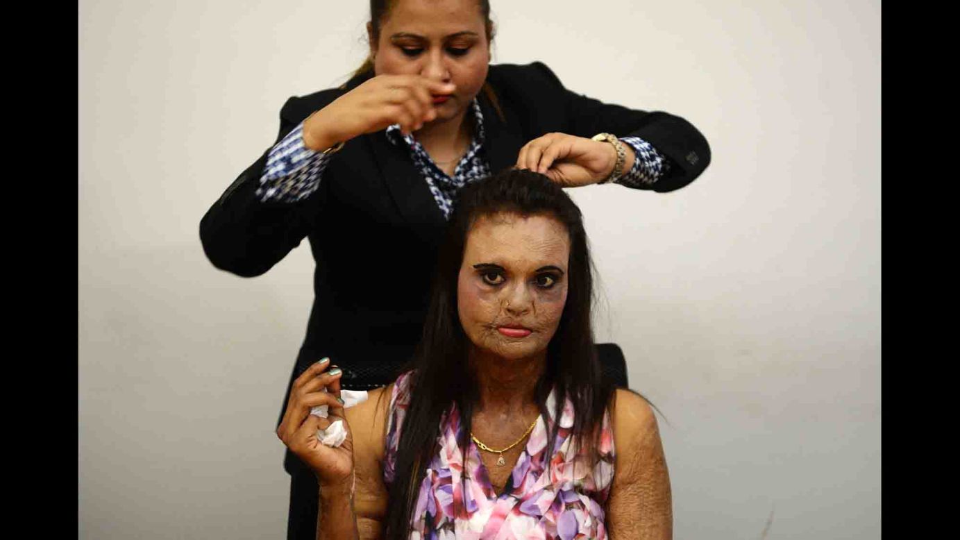 A woman in Thane, India, has her hair done Wednesday, March 7, before a fashion show meant to spread awareness about acid attacks.