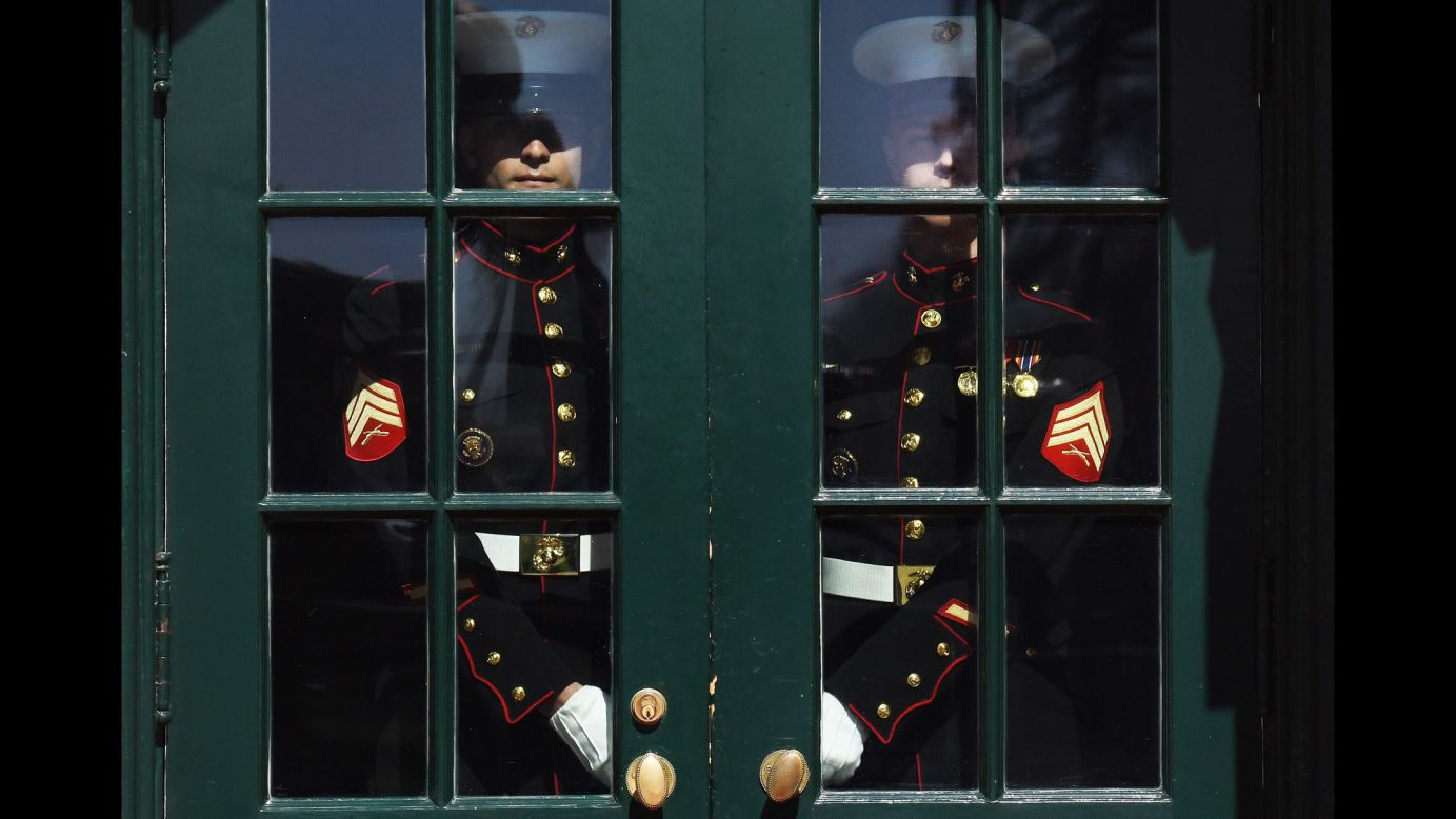 US Marines hold a White House door before the arrival of Israeli Prime Minister Benjamin Netanyahu and his wife, Sara, on Monday, March 5.