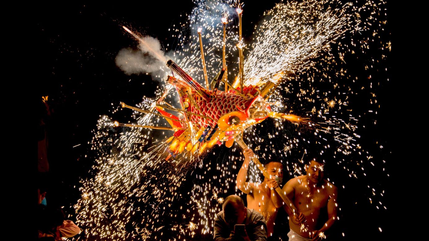 Men perform a fire dragon dance at the Lantern Festival in Meizhou, China, on Friday, March 2.