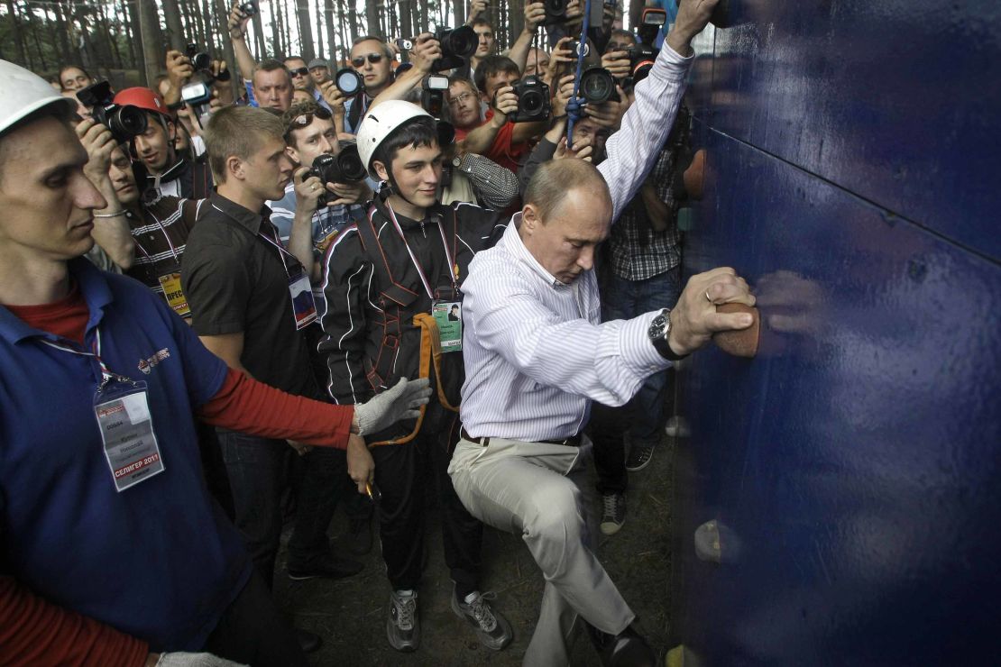 Putin scales a climbing wall at a summer camp run by the political Nashi youth group at Lake Seliger in northern Russia.