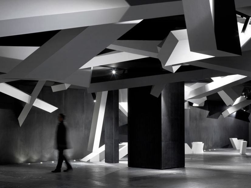 Pillar-like structures are strewn across the foyer beneath a canopy of angular shards.