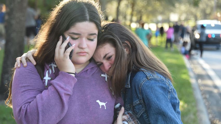 TOPSHOT - Students react following a shooting at Marjory Stoneman Douglas High School in Parkland, Florida, a city about 50 miles (80 kilometers) north of Miami on February 14, 2018.
A gunman opened fire at the Florida high school, an incident that officials said caused "numerous fatalities" and left terrified students huddled in their classrooms, texting friends and family for help.
The Broward County Sheriff's Office said a suspect was in custody. / AFP PHOTO / Michele Eve Sandberg        (Photo credit should read MICHELE EVE SANDBERG/AFP/Getty Images)