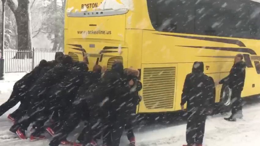 women basketball team push bus snow