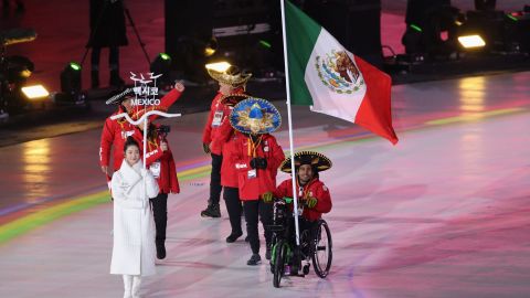 Mexico's sole competitor Arly Aristides Velasquez Penaloza carries his national flag into the arena