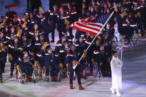 Team USA enter the arena in the Parade of Nations led by para snowboarder Mike Schultz.