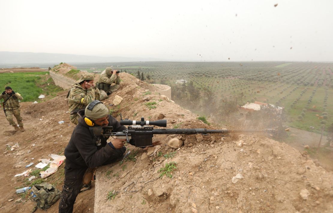 Turkish-backed Syrian rebels fight Kurdish forces on the outskirts of the town of Jandaris, on March 8, 