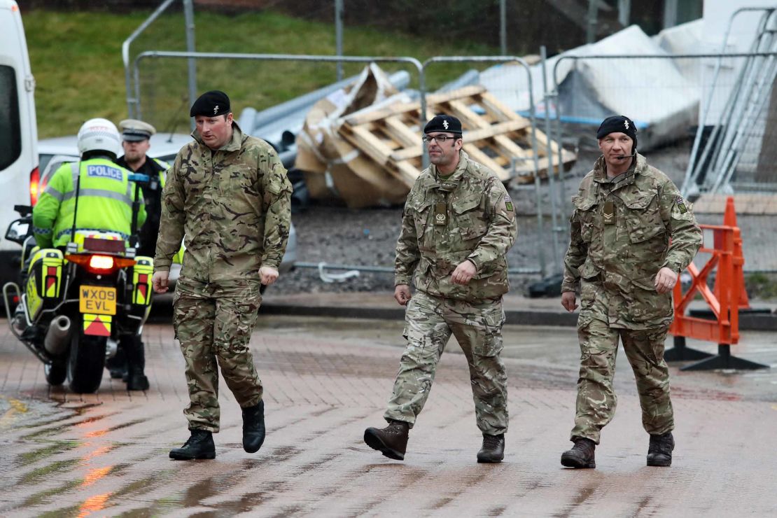 Military personnel are seen outside Salisbury District Hospital, Sunday.