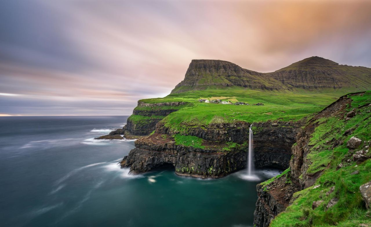 <strong>3. Denmark. </strong>Denmark has topped the list of the world's happiest countries three times, the last time in 2016. Perhaps the rugged nature celebrated and enjoyed by Danes is one reason why. Visitors can spot this waterfall in the village of Gasadalur on Vagar, one of the Faroe Islands. (This photo was taken with a long exposure.)