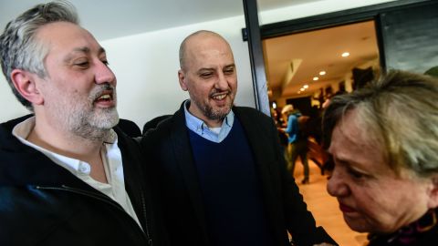Murat Sabuncu, left, and Ahmet Sık reunite with a colleague Saturday at their newspaper in Istanbul.