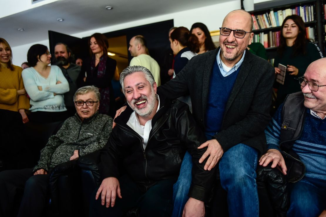 Colleagues welcome the release of Sabuncu, second left, and Sık, second right, on Saturday in Istanbul.