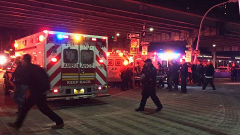 First responders carry a person to an ambulance after the helicopter crashed into the East River.