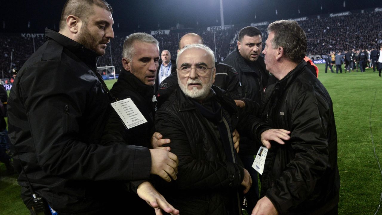 PAOK President Ivan Savvidis escorted out after carrying a pistol onto the pitch