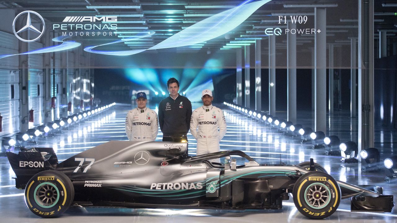 TOPSHOT - Mercedes AMG Petronas Formula One drivers Finland's Valtteri Bottas (L) and Britain's Lewis Hamilton (R), with Mercedes AMG Petronas Formula One Team Principal and Executive Director, Toto Wolff ,(C), pose alongside the new 2018 season Mercedes-AMG F1 W09 EQ Power+ Formula One car during its launch at Silverstone motor racing circuit near Towcester, central England on February 22, 2018.  / AFP PHOTO / Justin TALLIS        (Photo credit should read JUSTIN TALLIS/AFP/Getty Images)