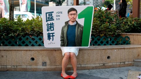 A supporter holds a poster of Hong Kong pro-democracy by-election winner Au Nok-hin.