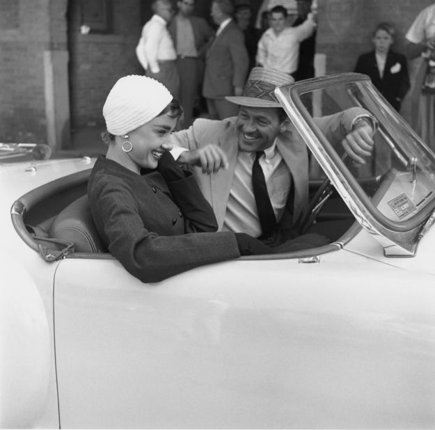 Hepburn and William Holden ride in a car on the set of "Sabrina."