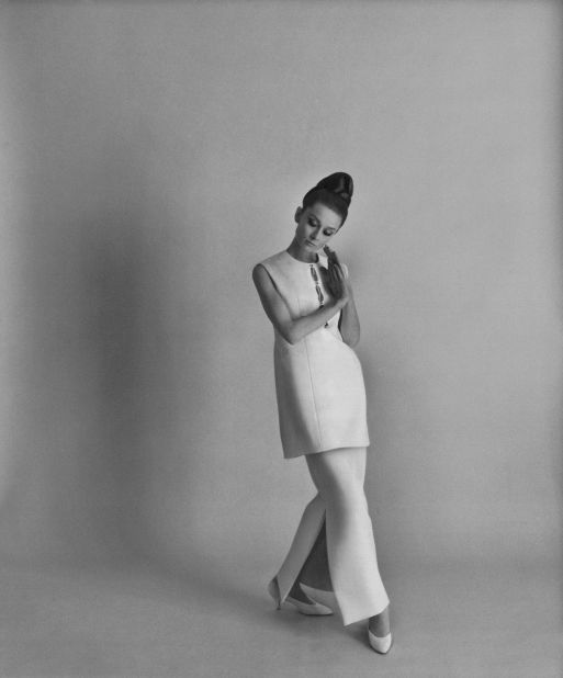 Hepburn wears a white linen tunic and underskirt with a slit to the knee.